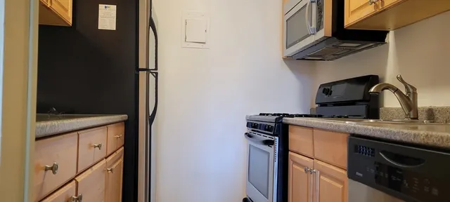 a kitchen with a sink and a refrigerator