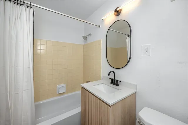 a bathroom with a sink toilet and a mirror