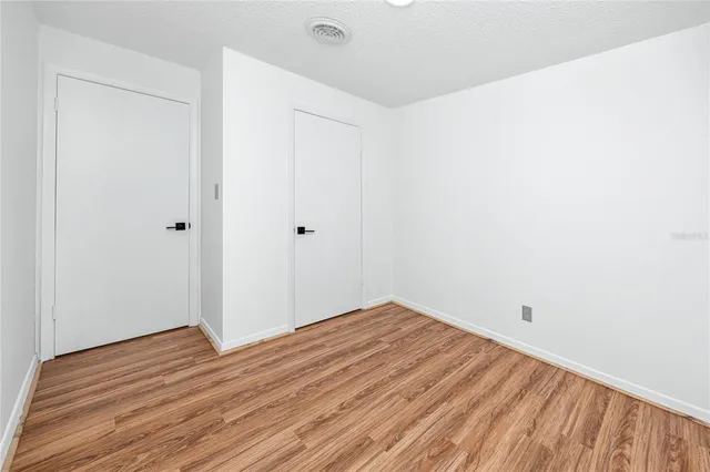 a view of room with wooden floor