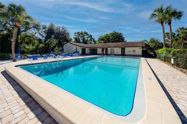 a view of swimming pool with a garden and deck