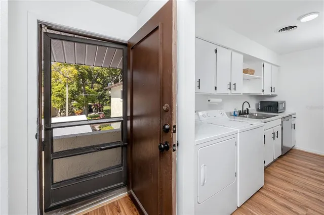 a kitchen with white cabinets and white appliances