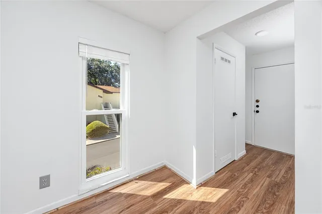 a view of room with wooden floor and closet