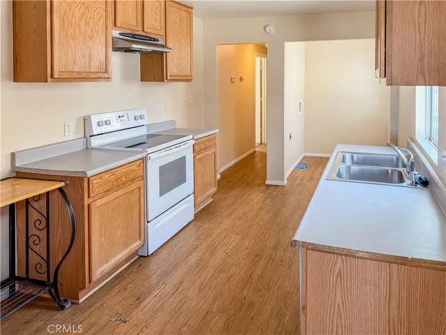 a kitchen with a sink a stove and cabinets