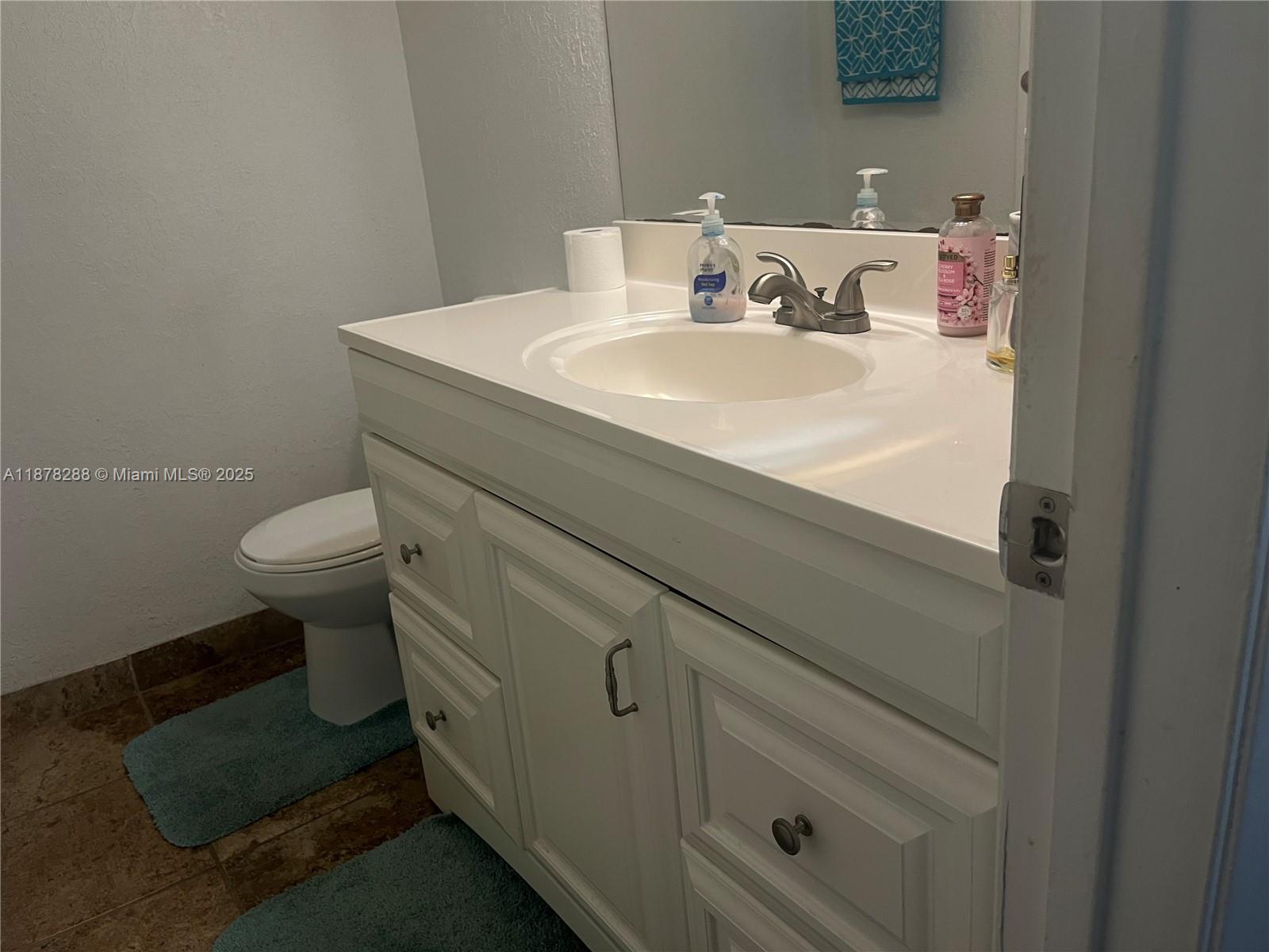 3720 North Pine Island Road, Unit 331 Sunrise, FL 33351 - Photo 14 of 22 a bathroom with a sink toilet and a mirror