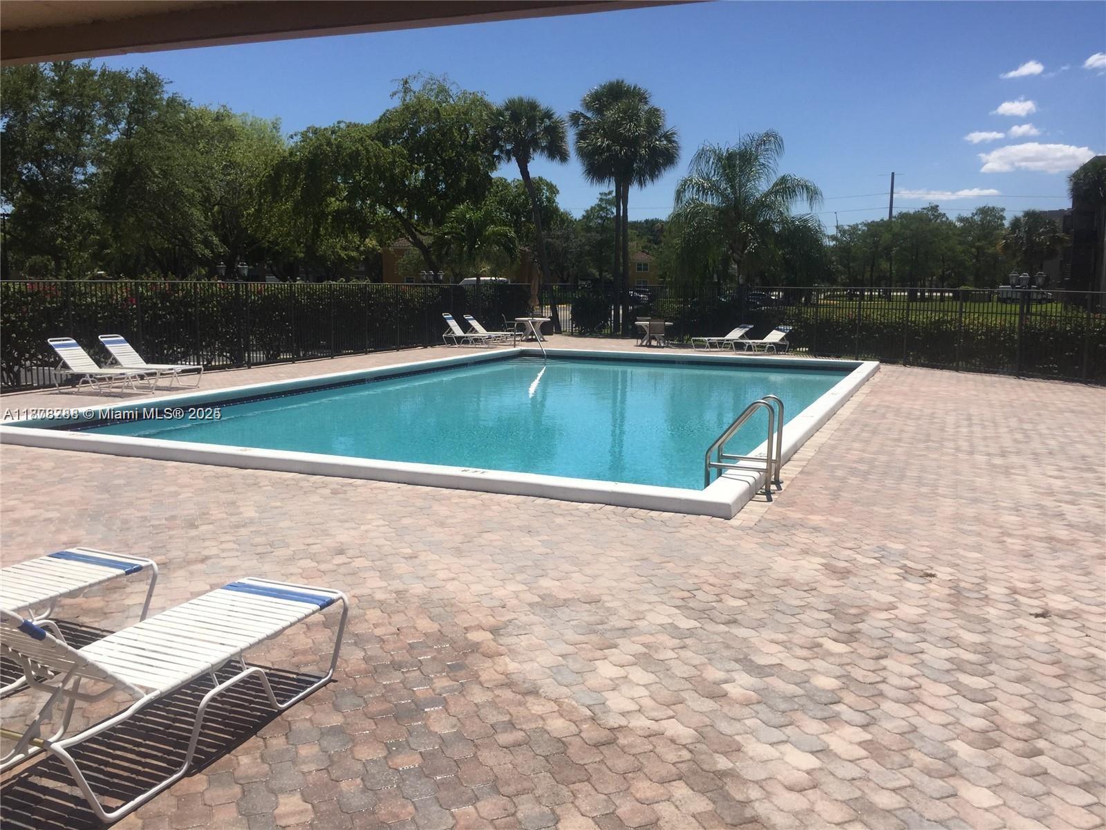 3720 North Pine Island Road, Unit 331 Sunrise, FL 33351 - Photo 21 of 22 a view of swimming pool with a yard and lake view