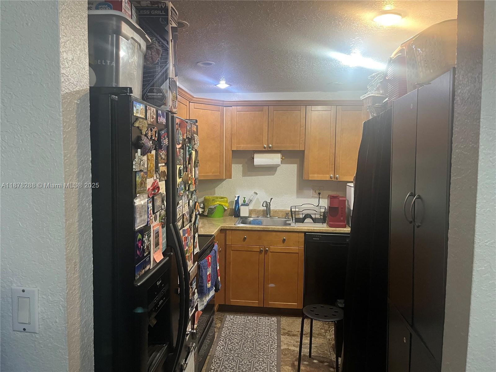 3720 North Pine Island Road, Unit 331 Sunrise, FL 33351 - Photo 5 of 22 a kitchen with refrigerator and cabinets