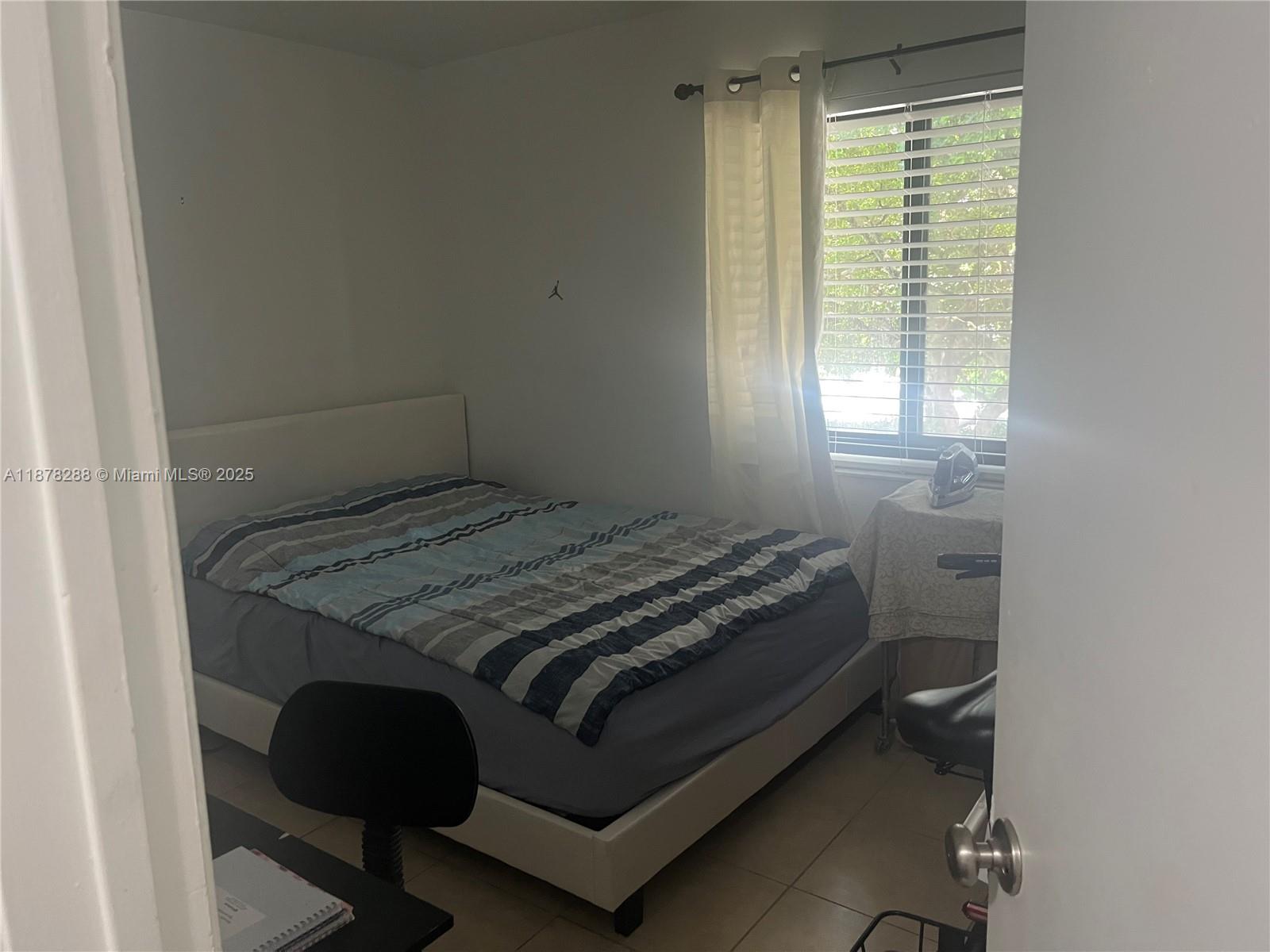 3720 North Pine Island Road, Unit 331 Sunrise, FL 33351 - Photo 9 of 22 a bedroom with a bed and a window