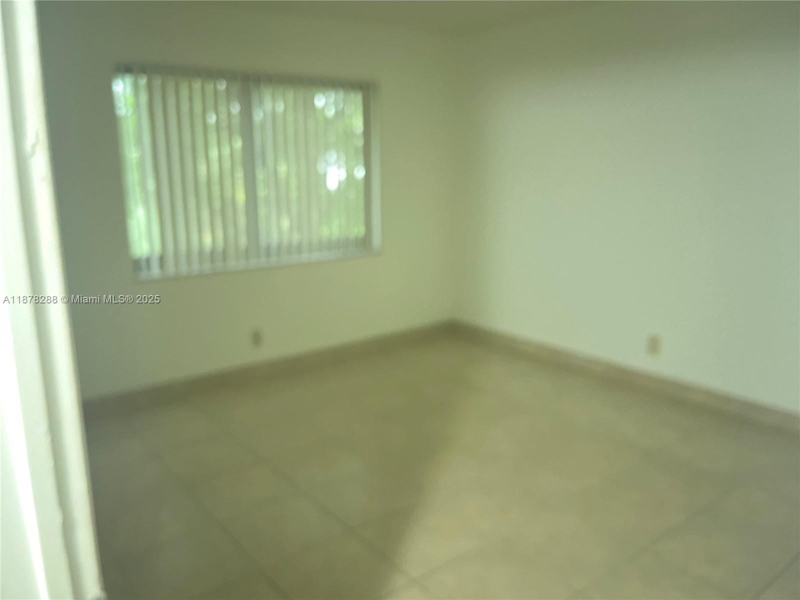 3720 North Pine Island Road, Unit 331 Sunrise, FL 33351 - Photo 10 of 22 an empty room with windows