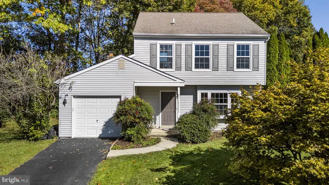 a aerial view of a house with yard and green space