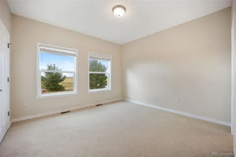 an empty room with windows and view