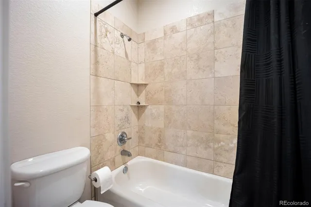 a bathroom with a toilet and shower