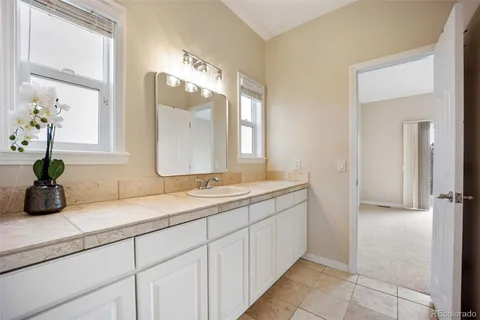 a bathroom with a double vanity sink and a mirror