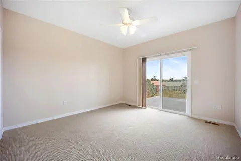 an empty room with a empty space and a ceiling fan