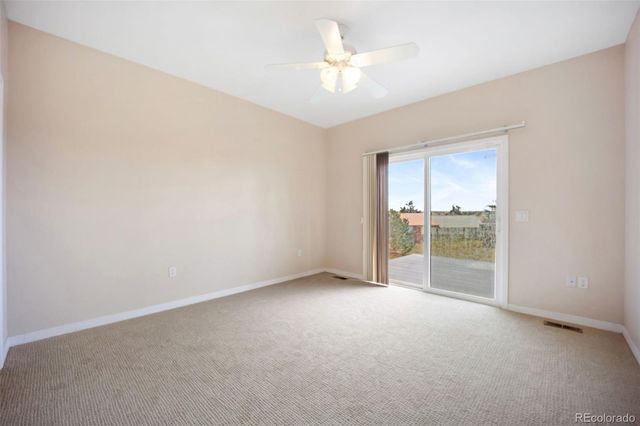 an empty room with a empty space and a ceiling fan