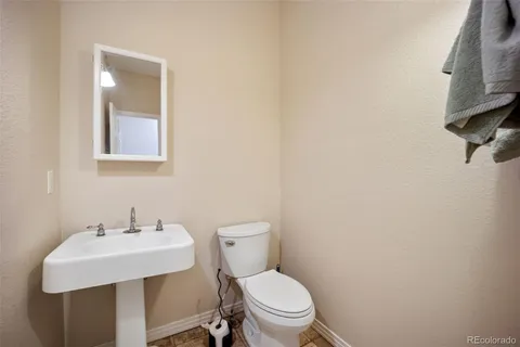 a white toilet sitting next to a bathroom sink