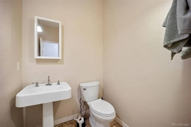 a white toilet sitting next to a bathroom sink