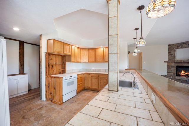 a kitchen with stainless steel appliances a stove a sink and a refrigerator