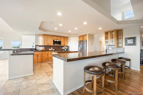 a kitchen with a table chairs sink and cabinets