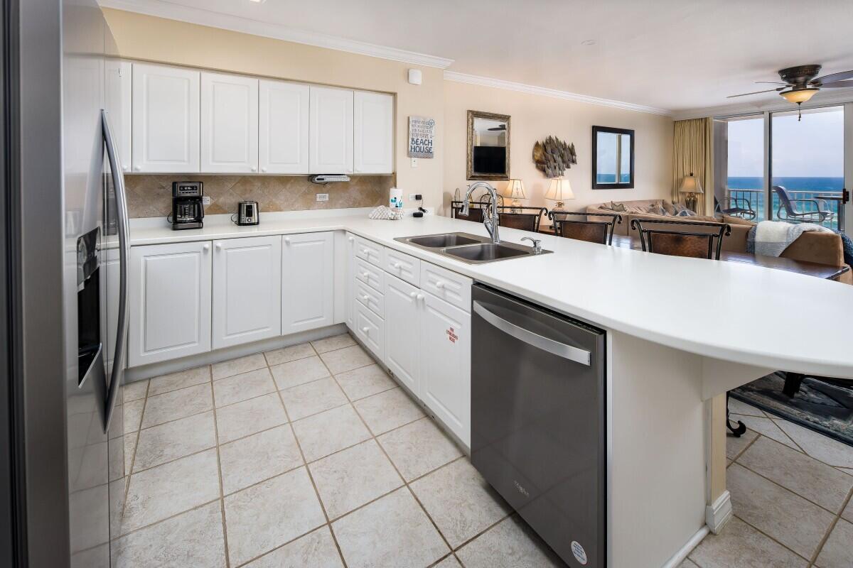 520 Santa Rosa Boulevard, Unit 605 Fort Walton Beach, FL 32548 - Photo 29 of 32 a kitchen with a sink a stove a refrigerator and cabinets