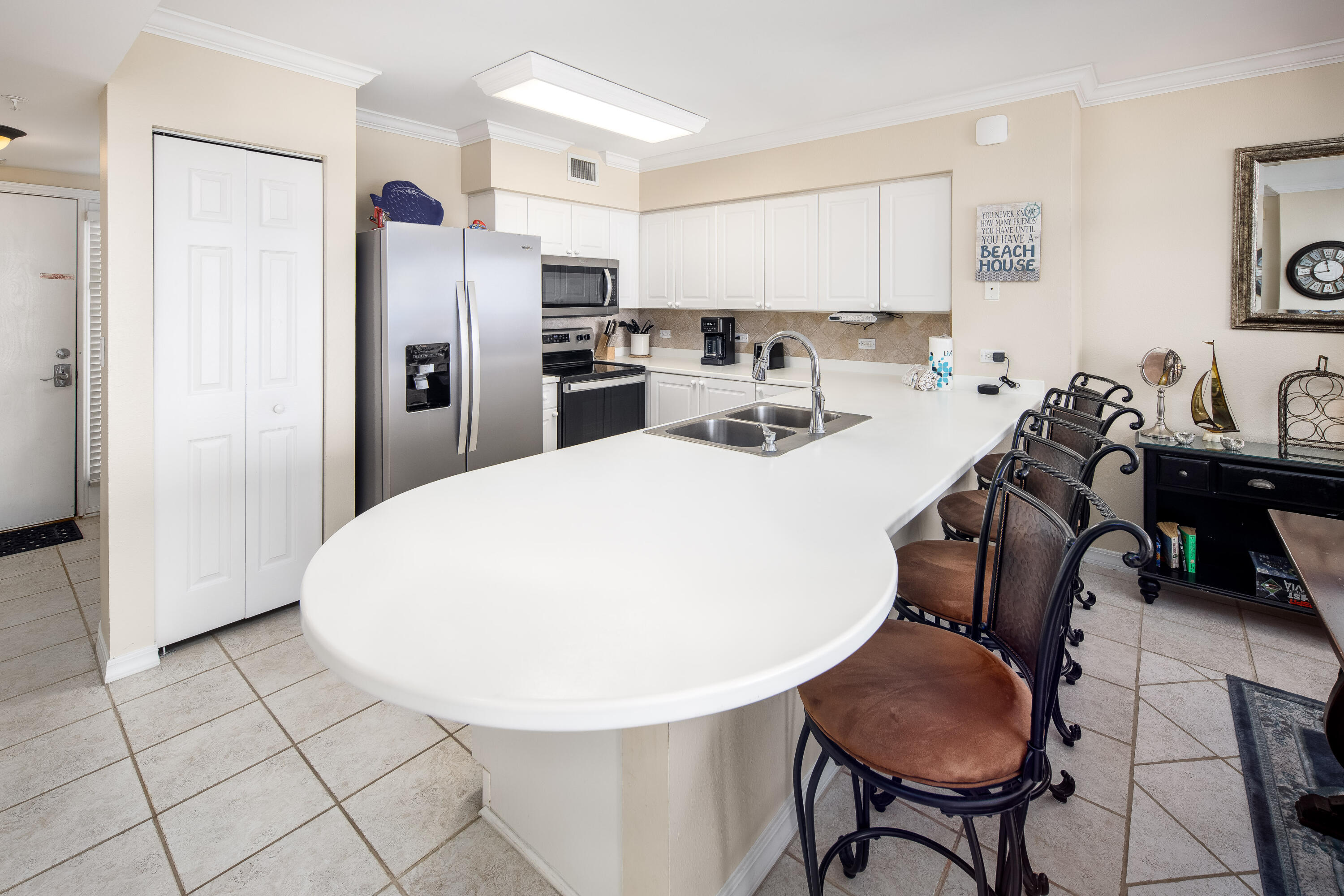 520 Santa Rosa Boulevard, Unit 605 Fort Walton Beach, FL 32548 - Photo 4 of 32 a kitchen with stainless steel appliances a refrigerator and a table chair