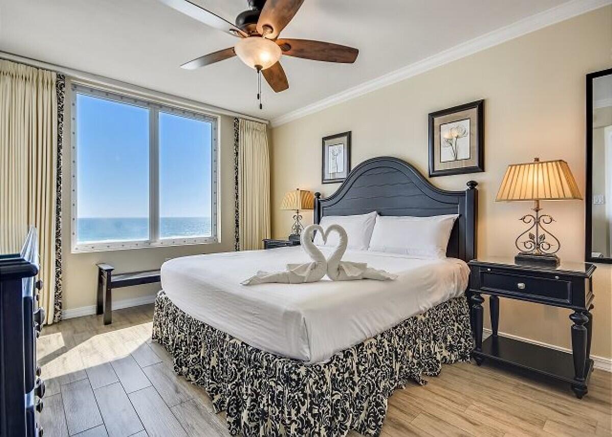 520 Santa Rosa Boulevard, Unit 605 Fort Walton Beach, FL 32548 - Photo 6 of 32 a large bedroom with a bed and wooden floor