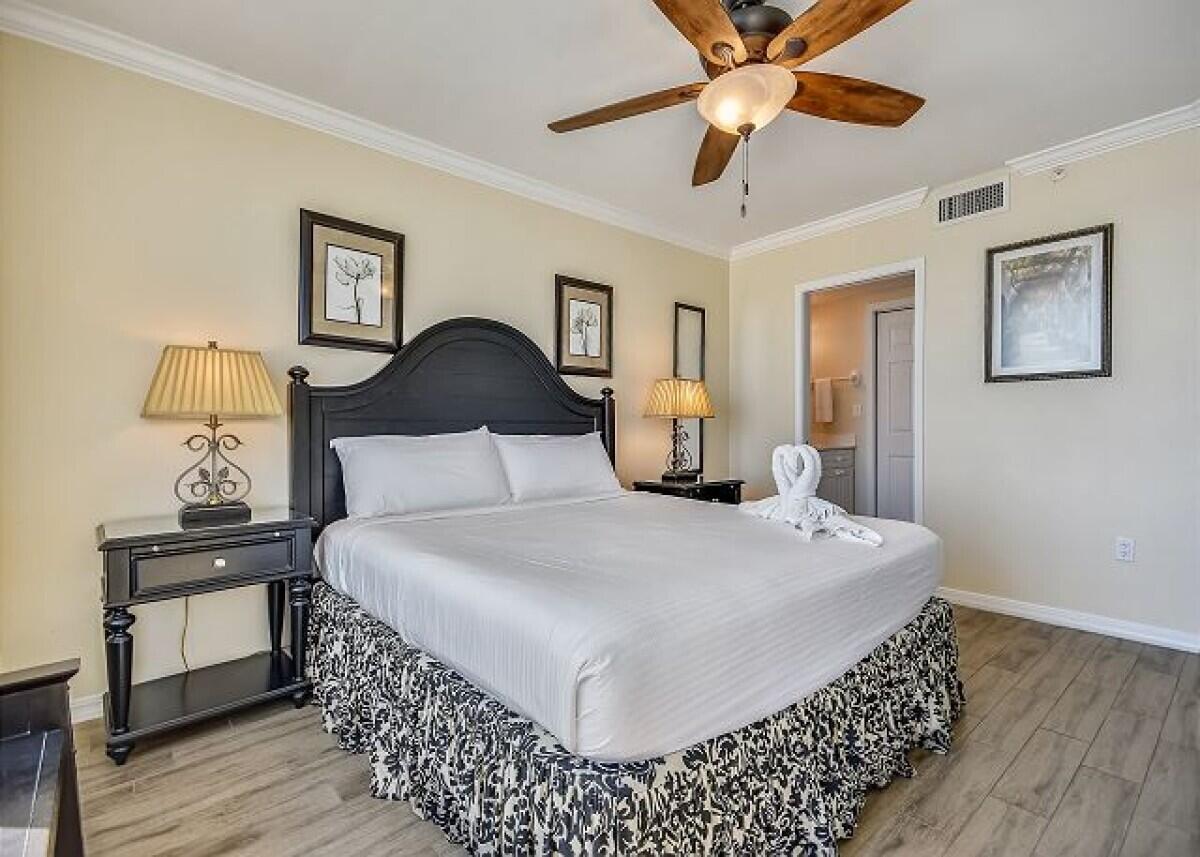 520 Santa Rosa Boulevard, Unit 605 Fort Walton Beach, FL 32548 - Photo 7 of 32 a bedroom with a bed and wooden floor