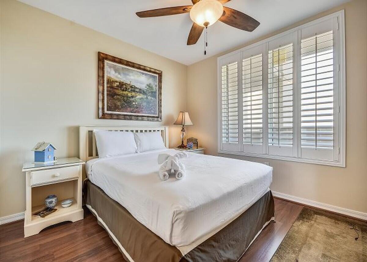 520 Santa Rosa Boulevard, Unit 605 Fort Walton Beach, FL 32548 - Photo 9 of 32 a bedroom with a bed and a chandelier