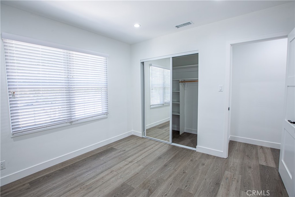 19503 Cantara Street Reseda, CA 91335 - Photo 13 of 19 an empty room with wooden floor and windows