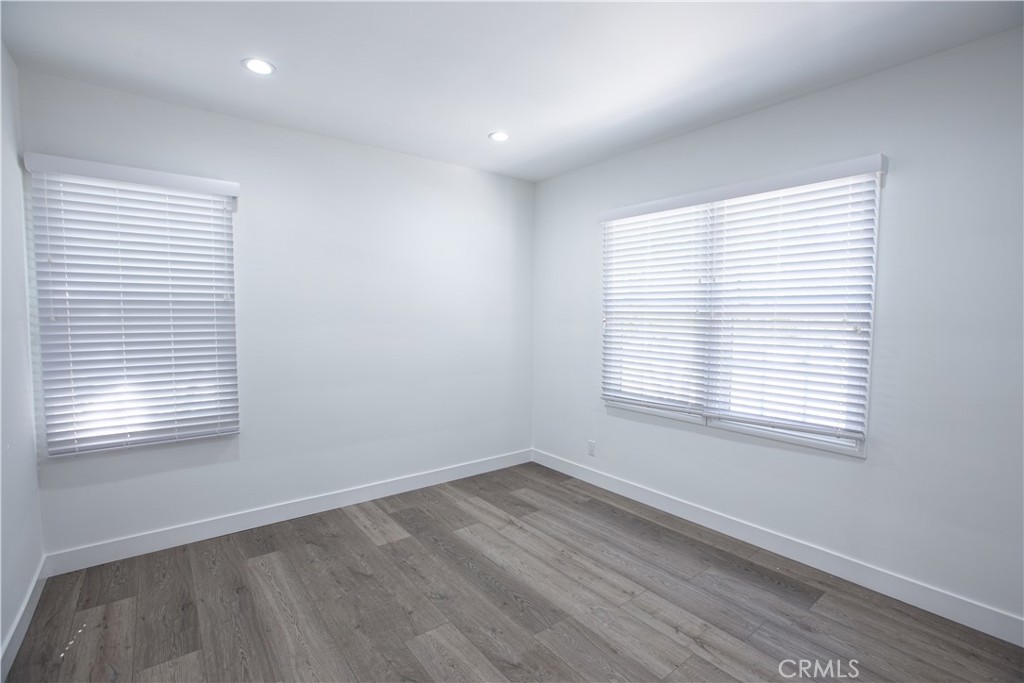 19503 Cantara Street Reseda, CA 91335 - Photo 14 of 19 a view of an empty room with wooden floor and a window
