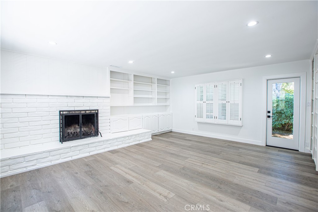 19503 Cantara Street Reseda, CA 91335 - Photo 2 of 19 an empty room with wooden floor and fireplace