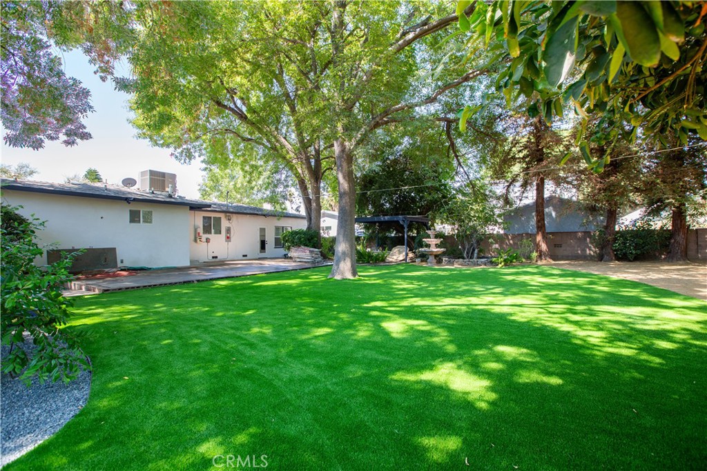 19503 Cantara Street Reseda, CA 91335 - Photo 3 of 19 a view of a backyard with table and chairs and a large tree