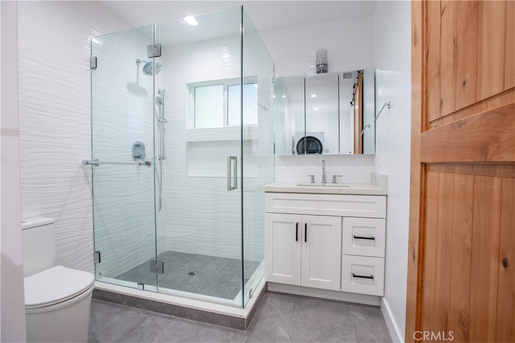 19503 Cantara Street Reseda, CA 91335 - Photo 5 of 19 a bathroom with a shower sink vanity and toilet