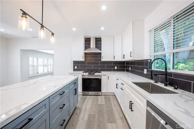 a kitchen with granite countertop a sink stove and cabinets