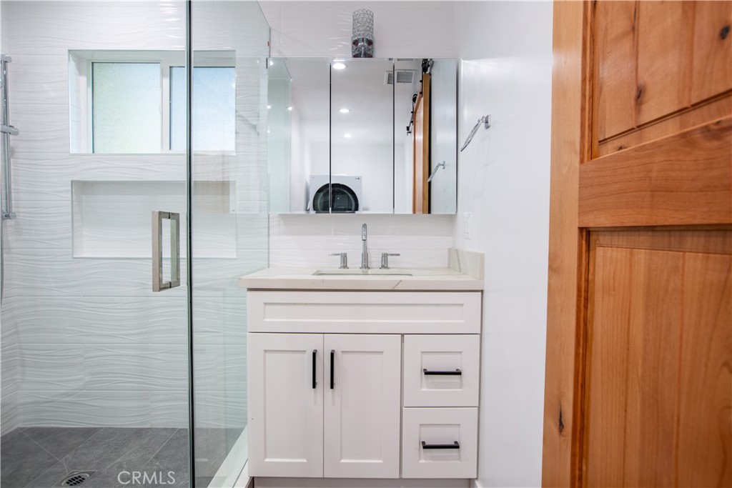 19503 Cantara Street Reseda, CA 91335 - Photo 10 of 19 a bathroom with a shower sink and mirror