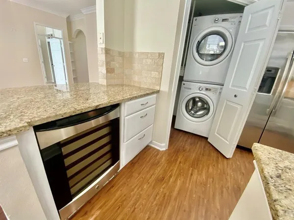a view of washer and dryer with bathroom in the background
