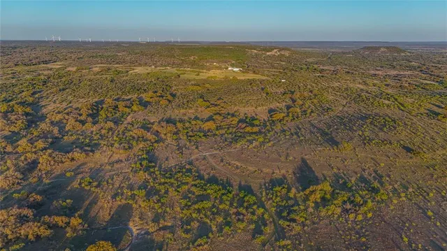 a view of a field with an ocean