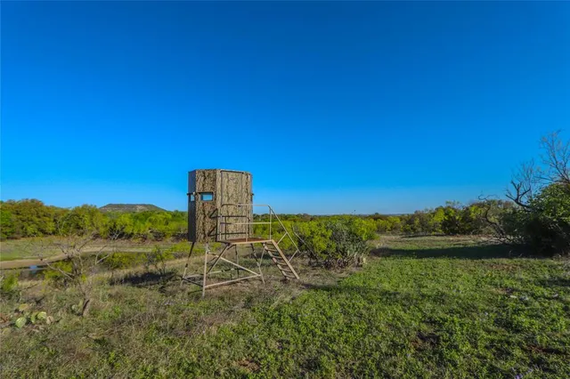 a view of outdoor space with trees all around