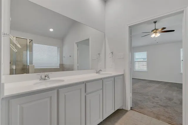 a bathroom with a double vanity sink and a mirror