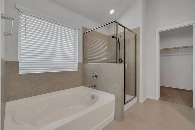 a bathroom with a tub and a shower