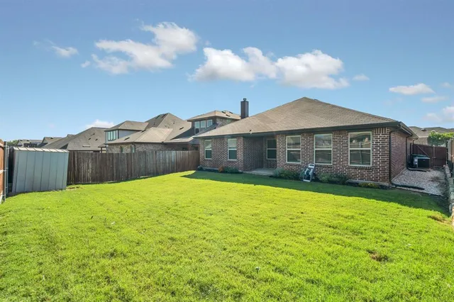 a view of a house with a backyard and a garden