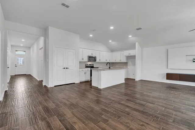 a view of kitchen with wooden floor and electronic appliances