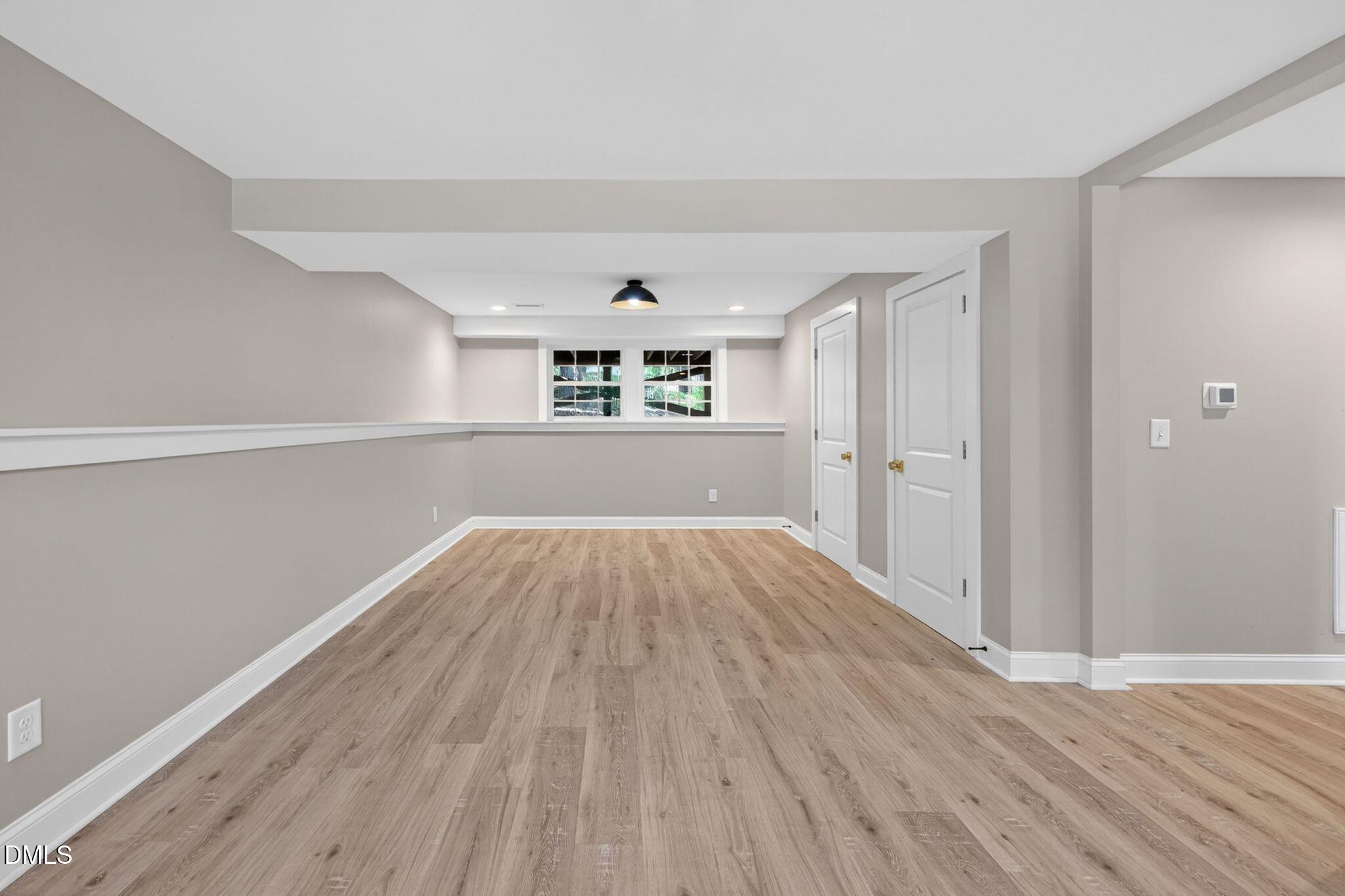 313 Crown Oaks Drive Raleigh, NC 27615 - Photo 58 of 60 wooden floor in an empty room with window and wooden floor