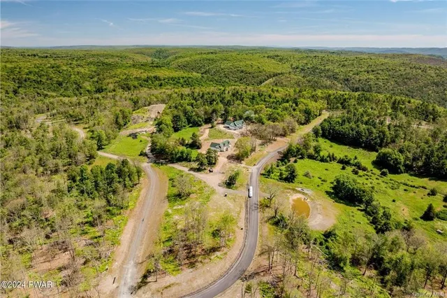 an aerial view of residential houses with outdoor space