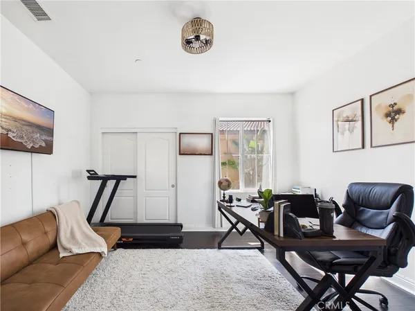 a spacious bedroom with a bed a table and a window