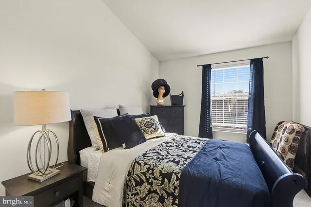 a bedroom with bed and a window