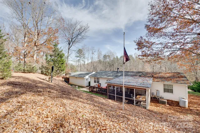 a view of a house with a yard covered with snow