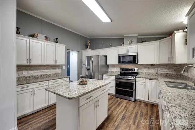 a kitchen with a sink stove and refrigerator
