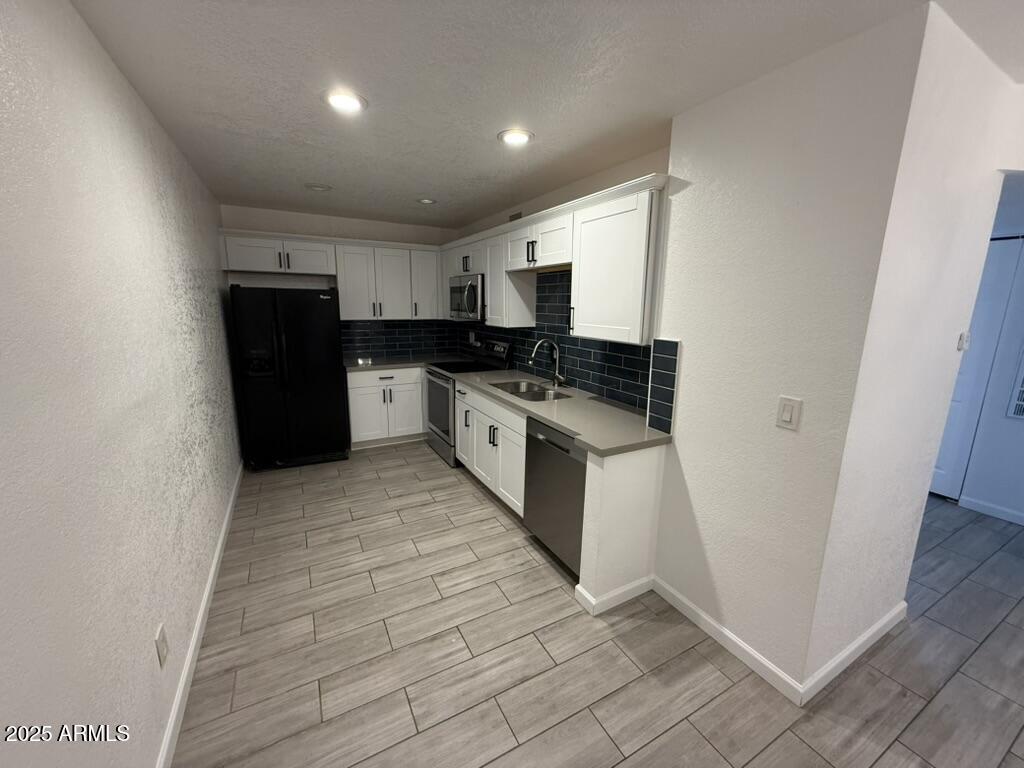 234 East Ruth Avenue, Unit 3 Phoenix, AZ 85020 - Photo 1 of 6 a kitchen with a sink and a stove top oven