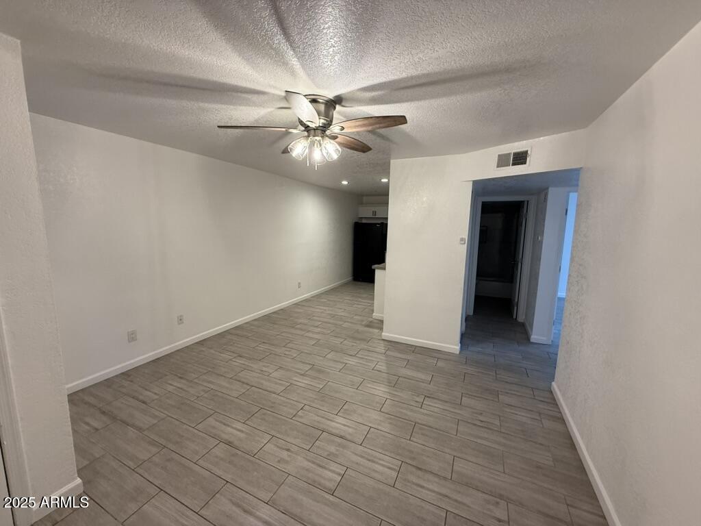 234 East Ruth Avenue, Unit 3 Phoenix, AZ 85020 - Photo 2 of 6 an empty room with fan and a ceiling fan