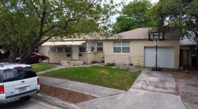 a front view of a house with a garden